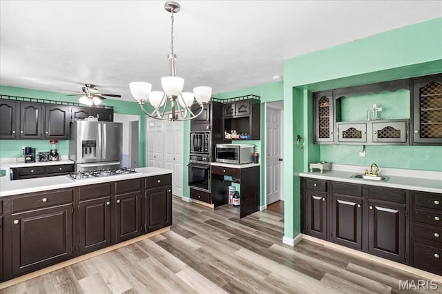 27 Heatherwood Dr, Collinsville, IL 62234 - kitchen with appliances with stainless steel finishes, light countertops, a sink, a chandelier, and light wood finished floors