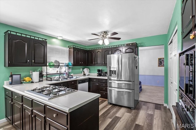 27 Heatherwood Dr, Collinsville, IL 62234 - kitchen with appliances with stainless steel finishes, light countertops, a peninsula, a ceiling fan, and a sink