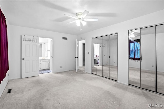 27 Heatherwood Dr, Collinsville, IL 62234 - unfurnished bedroom with two closets, carpet flooring, baseboards, connected bathroom, and a ceiling fan