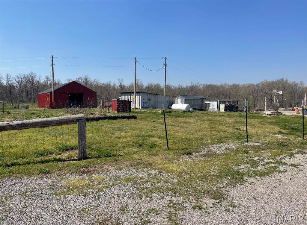 25725 Misty Oak Dr, Lebanon, MO 65536 - view of grassy yard with an outdoor structure and an outbuilding