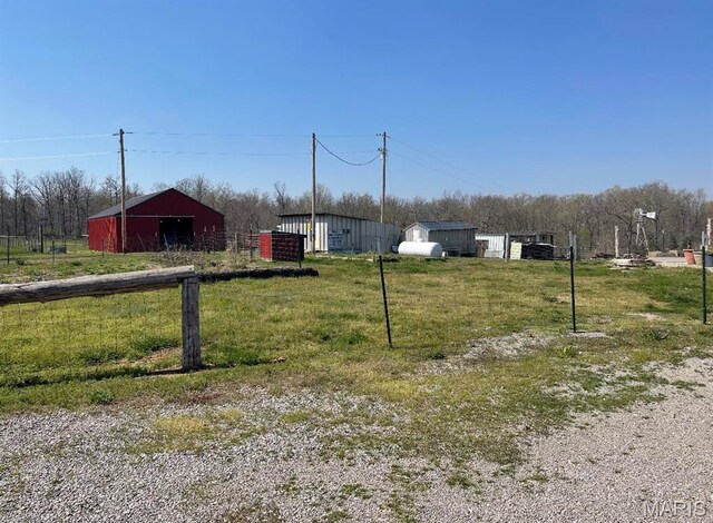 25725 Misty Oak Dr, Lebanon, MO 65536 - view of grassy yard with an outdoor structure and an outbuilding