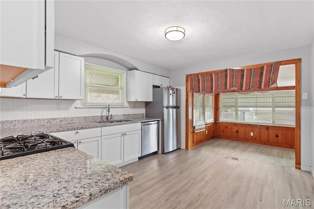 3700 Viking, Saint Louis, MO 63125 - kitchen featuring a sink, stainless steel appliances, white cabinetry, and light wood finished floors