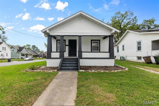 view of front of property featuring a porch, central air condition unit, a front lawn, and a residential view