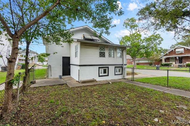 view of front of house with a gate and stucco siding