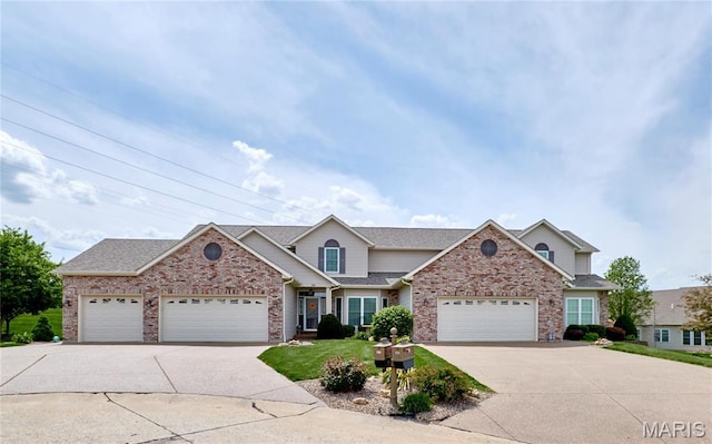 225 River Bluff Ct, Troy, MO 63379 - traditional-style home featuring driveway, an attached garage, brick siding, and roof with shingles