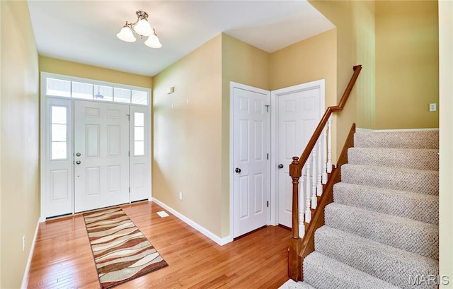 225 River Bluff Ct, Troy, MO 63379 - foyer entrance with light wood-style flooring, stairs, and baseboards