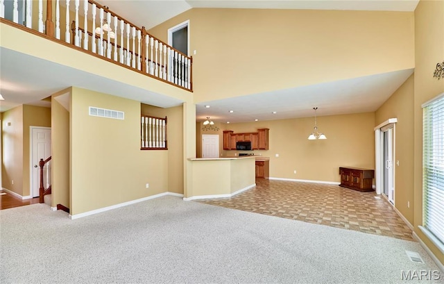 225 River Bluff Ct, Troy, MO 63379 - unfurnished living room featuring light colored carpet, baseboards, high vaulted ceiling, and healthy amount of natural light