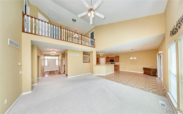 225 River Bluff Ct, Troy, MO 63379 - unfurnished living room with light carpet, baseboards, high vaulted ceiling, ceiling fan, and healthy amount of natural light
