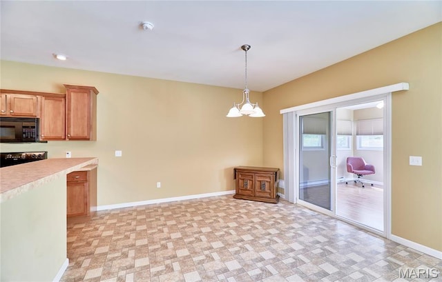 225 River Bluff Ct, Troy, MO 63379 - kitchen with black microwave, light countertops, range, a chandelier, and baseboards