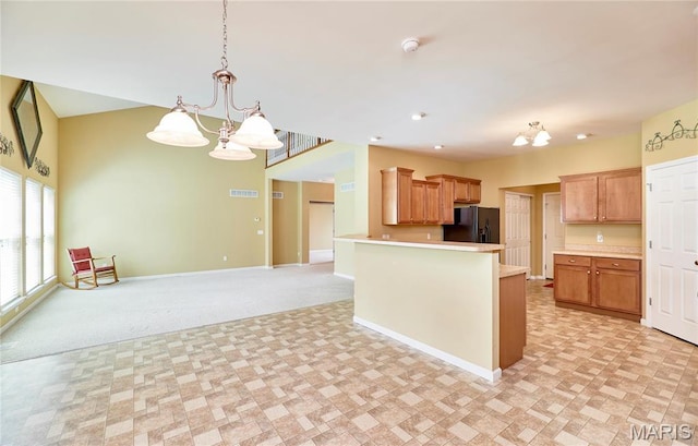 225 River Bluff Ct, Troy, MO 63379 - kitchen with a chandelier, black fridge with ice dispenser, baseboards, and light countertops