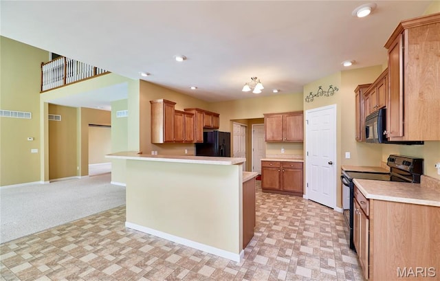 225 River Bluff Ct, Troy, MO 63379 - kitchen featuring black appliances, a peninsula, light countertops, baseboards, and brown cabinetry