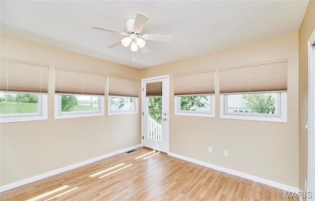 225 River Bluff Ct, Troy, MO 63379 - spare room featuring healthy amount of natural light, baseboards, wood finished floors, and a ceiling fan