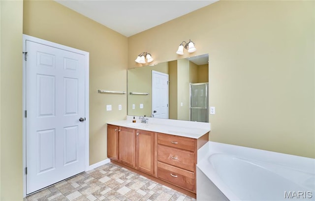 225 River Bluff Ct, Troy, MO 63379 - bathroom with a garden tub, vanity, a shower stall, baseboards, and stone finish floors