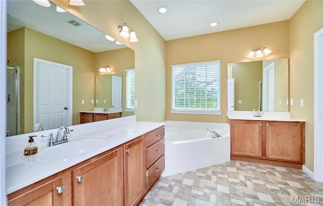 225 River Bluff Ct, Troy, MO 63379 - full bath featuring a garden tub, two vanities, and a stall shower