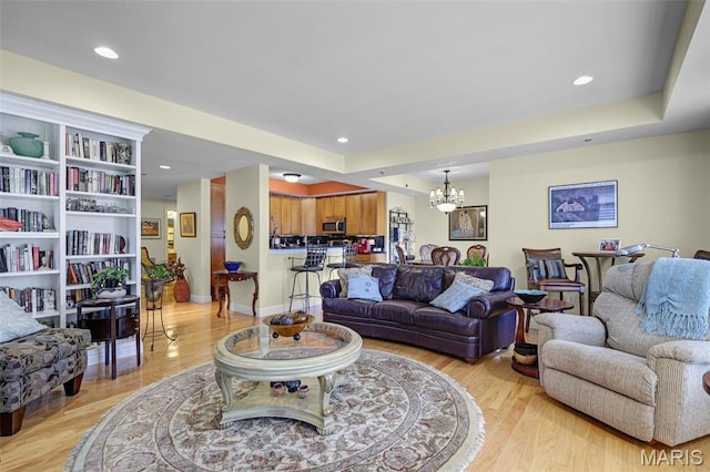 living area featuring a chandelier, light wood-type flooring, and recessed lighting