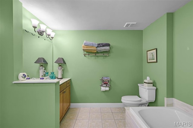 full bathroom featuring vanity, a tub to relax in, tile patterned floors, toilet, and baseboards