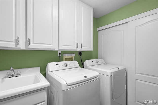 laundry room featuring cabinet space and separate washer and dryer