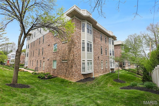 view of side of property featuring brick siding
