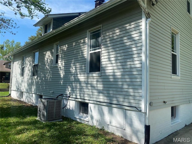 616 N Church St, Belleville, IL 62220 - view of side of property with central AC, a chimney, and a lawn