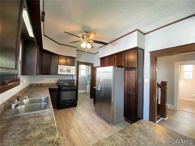 616 N Church St, Belleville, IL 62220 - kitchen featuring black gas range oven, stainless steel fridge, a sink, white microwave, and dark countertops