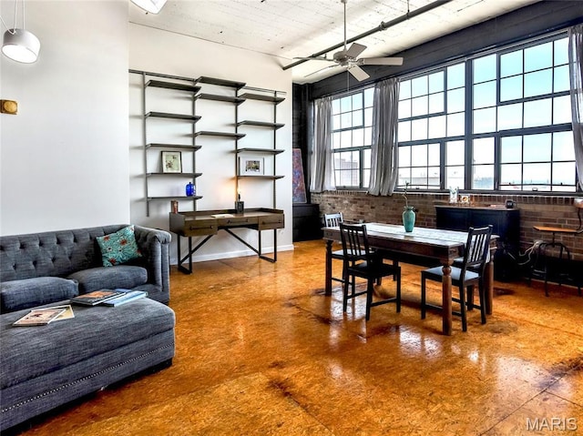 dining room featuring finished concrete floors and ceiling fan