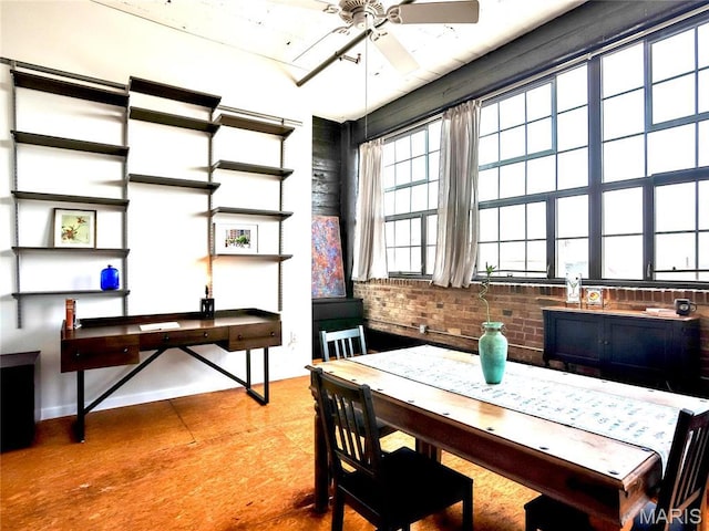 office with ceiling fan and brick wall