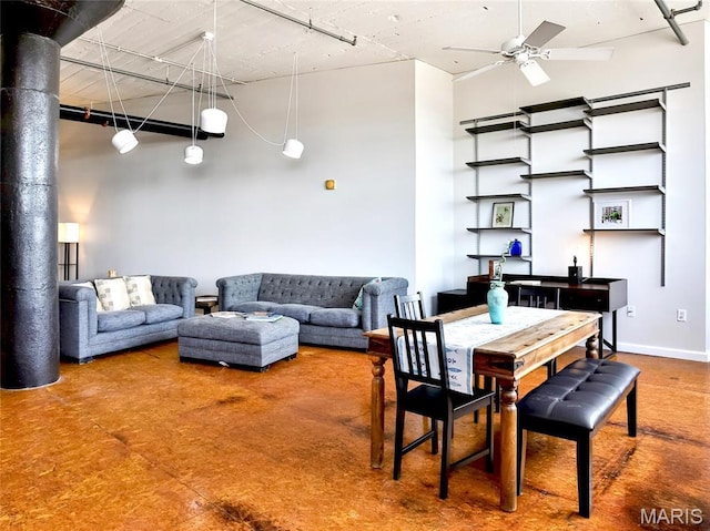 dining room featuring ceiling fan and a towering ceiling