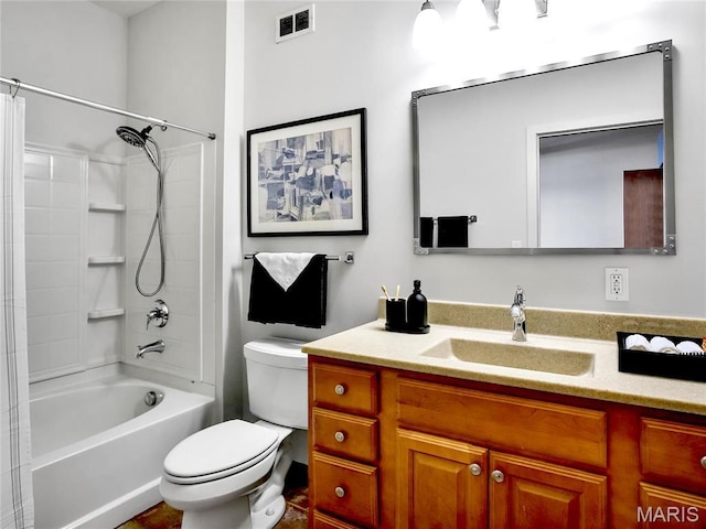 bathroom featuring toilet, vanity, and shower / tub combination