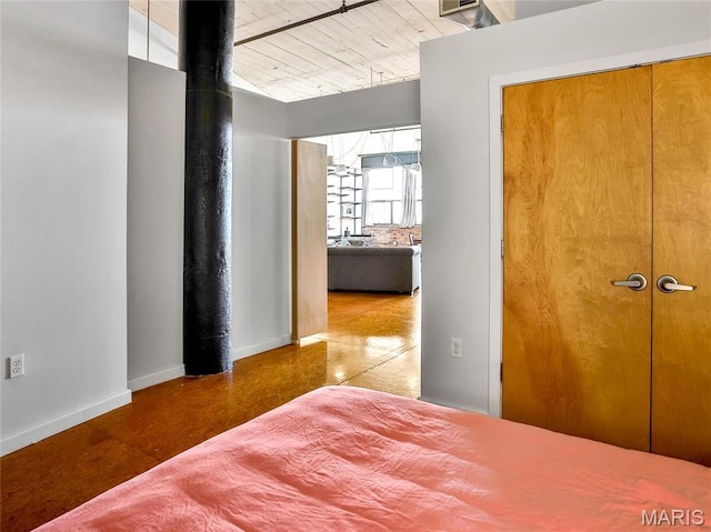bedroom with baseboards and vaulted ceiling