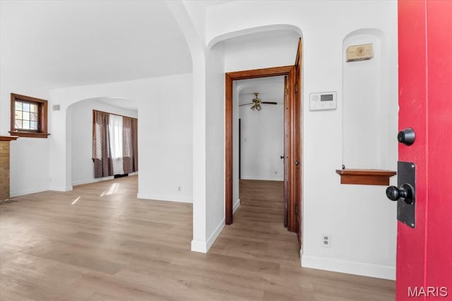 5034 Queens Ave, Saint Louis, MO 63115 - hall featuring arched walkways, light wood-style floors, and baseboards