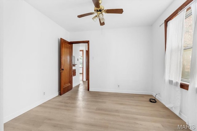 5034 Queens Ave, Saint Louis, MO 63115 - spare room featuring a ceiling fan, light wood-type flooring, and baseboards