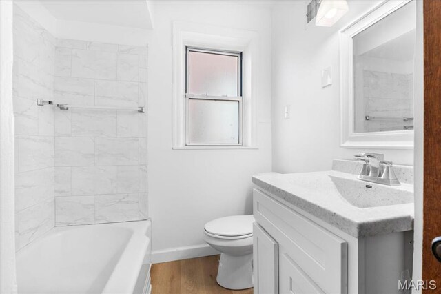 5034 Queens Ave, Saint Louis, MO 63115 - full bathroom featuring toilet, vanity, wood finished floors, baseboards, and shower / bathtub combination