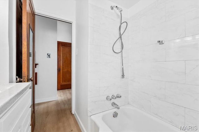5034 Queens Ave, Saint Louis, MO 63115 - bathroom featuring wood finished floors, shower / tub combination, and baseboards