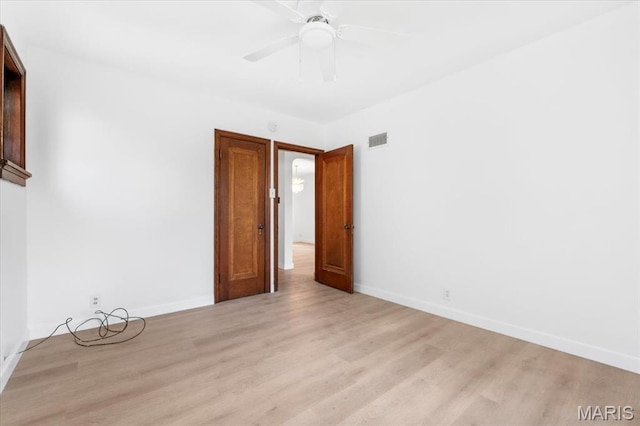 5034 Queens Ave, Saint Louis, MO 63115 - empty room with light wood finished floors, baseboards, and ceiling fan