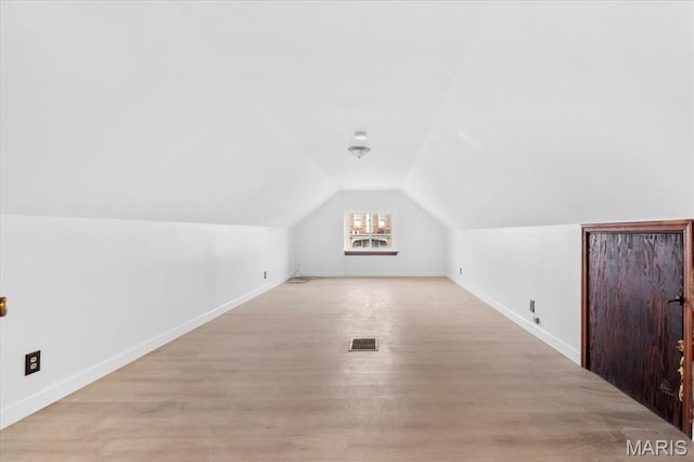 5034 Queens Ave, Saint Louis, MO 63115 - bonus room with baseboards, lofted ceiling, and light wood-type flooring