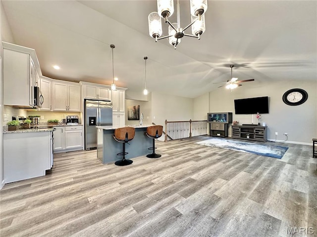 3553 Chippewa Dr, Shiloh, IL 62221 - kitchen featuring stainless steel appliances, a breakfast bar area, lofted ceiling, light wood-type flooring, and white cabinetry