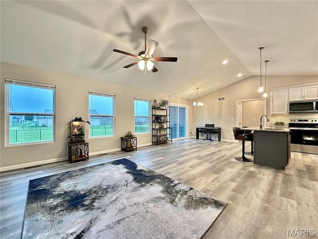 3553 Chippewa Dr, Shiloh, IL 62221 - living room with light wood-type flooring, lofted ceiling, ceiling fan, baseboards, and a chandelier