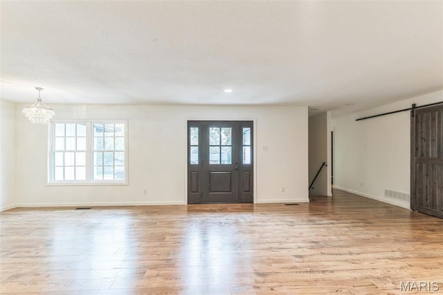 11 Forrester Dr, Manchester, MO 63011 - entryway with a barn door, light wood finished floors, a chandelier, baseboards, and recessed lighting