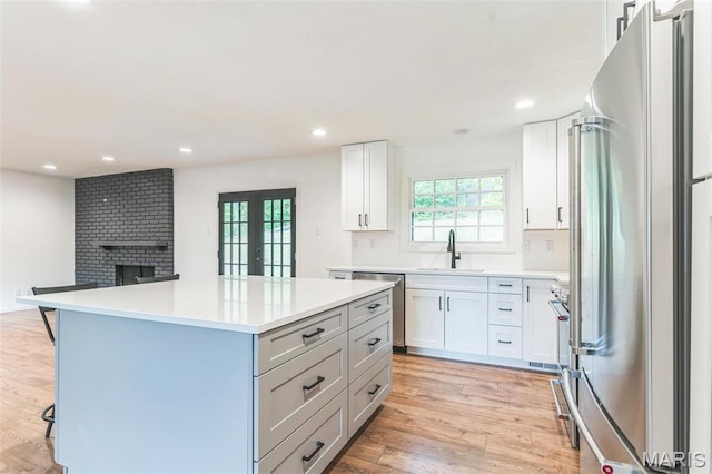 11 Forrester Dr, Manchester, MO 63011 - kitchen with appliances with stainless steel finishes, plenty of natural light, a sink, a breakfast bar, and recessed lighting