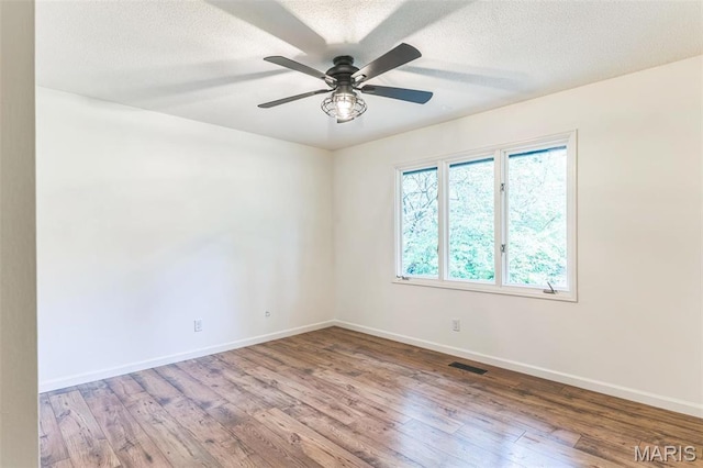 11 Forrester Dr, Manchester, MO 63011 - unfurnished room featuring baseboards, wood finished floors, ceiling fan, and a textured ceiling