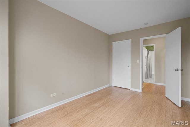 4466 W Pine Blvd Unit 2E, Saint Louis, MO 63108 - unfurnished room with light wood-style floors and baseboards