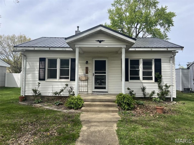 417 E 5th St, Ramsey, IL 62080 - bungalow featuring covered porch, metal roof, and central air condition unit