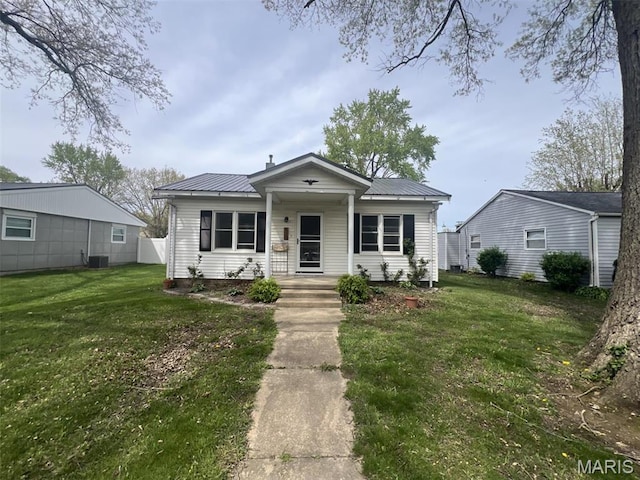 417 E 5th St, Ramsey, IL 62080 - bungalow featuring metal roof, a front yard, and central AC unit