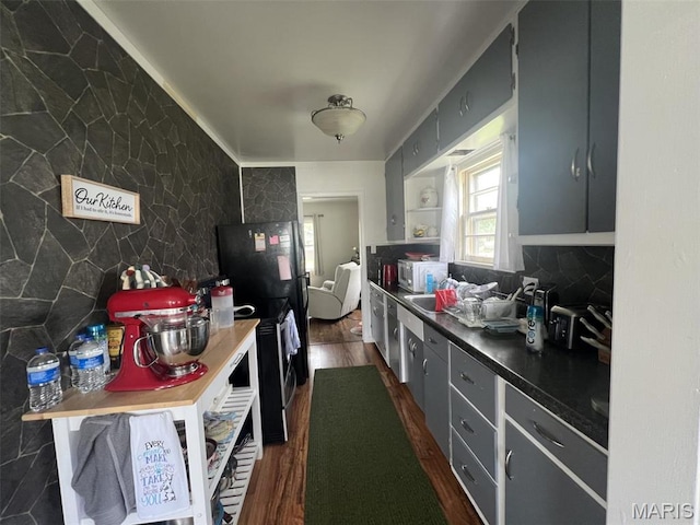 417 E 5th St, Ramsey, IL 62080 - kitchen featuring dark wood-type flooring, dark countertops, backsplash, and a sink