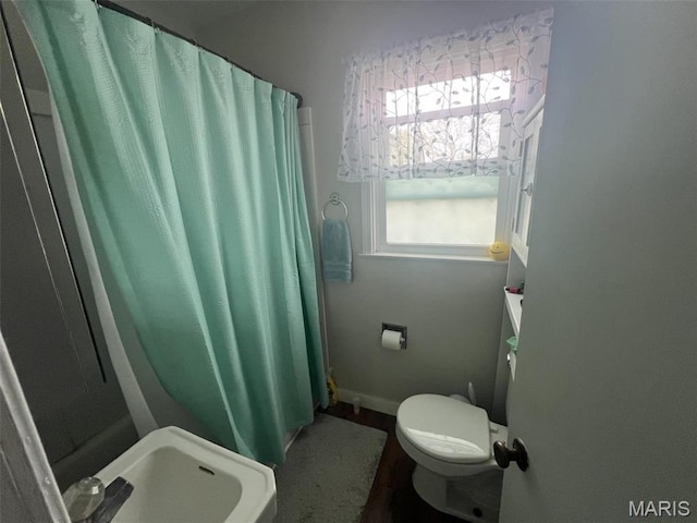 417 E 5th St, Ramsey, IL 62080 - full bathroom with toilet, curtained shower, wood finished floors, and baseboards