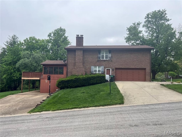 view of front facade with driveway, a chimney, an attached garage, a front lawn, and brick siding