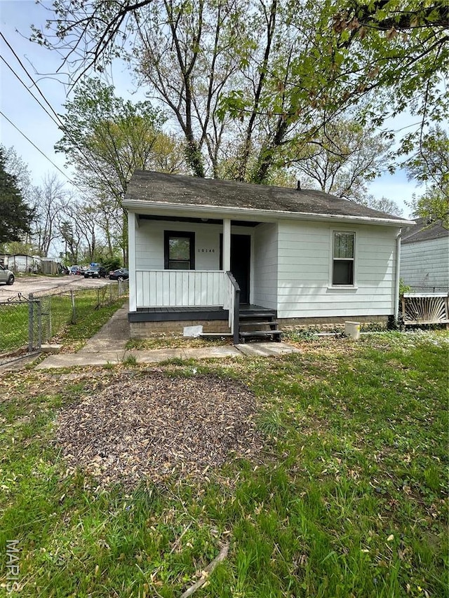 10140 Mayfair Dr, Saint Louis, MO 63136 - view of front of property featuring covered porch, fence, cooling unit, and a shingled roof
