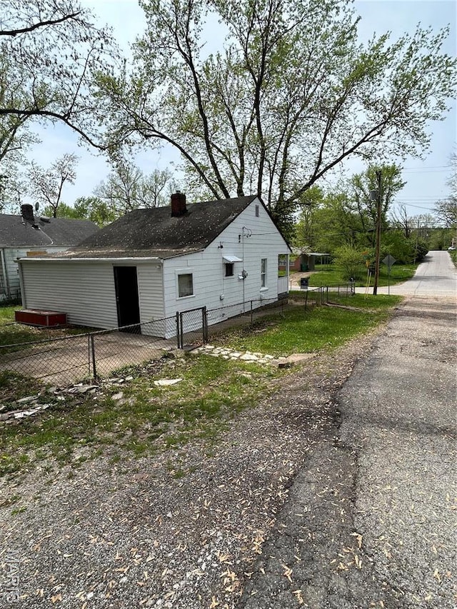 10140 Mayfair Dr, Saint Louis, MO 63136 - view of side of home with a chimney and fence