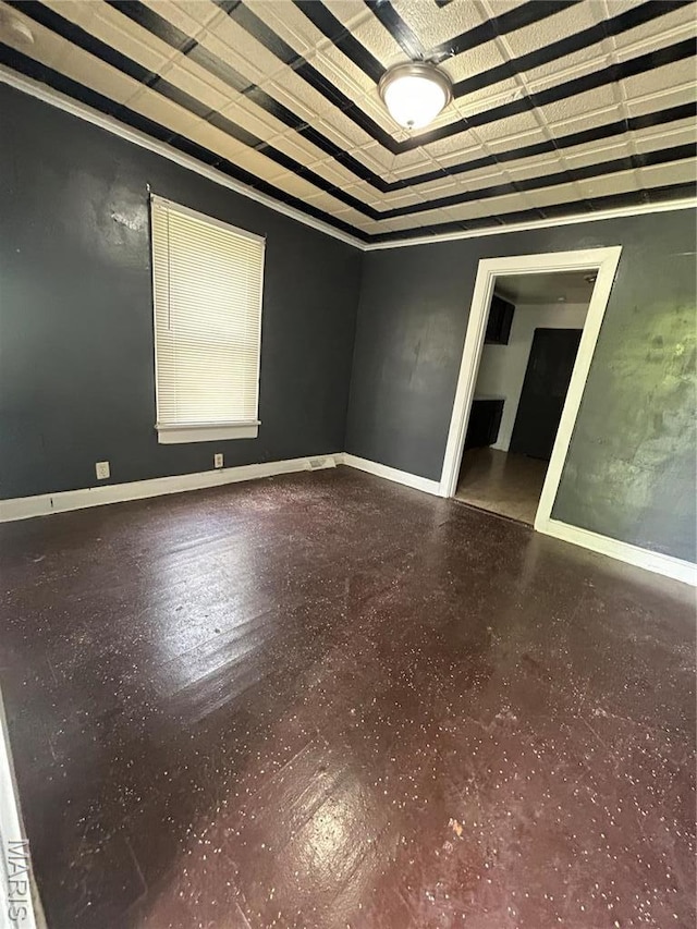 10140 Mayfair Dr, Saint Louis, MO 63136 - unfurnished room featuring baseboards, a tray ceiling, and speckle patterned floor