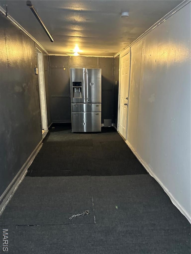 10140 Mayfair Dr, Saint Louis, MO 63136 - garage featuring stainless steel refrigerator with ice dispenser and baseboards